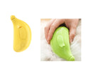 Two handheld devices resembling bananas, one yellow and one green, being used on a white surface.