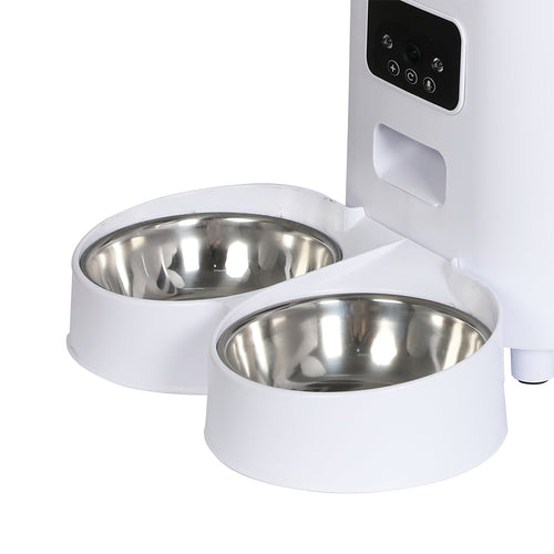 White pet feeder with stainless steel bowls on a white background