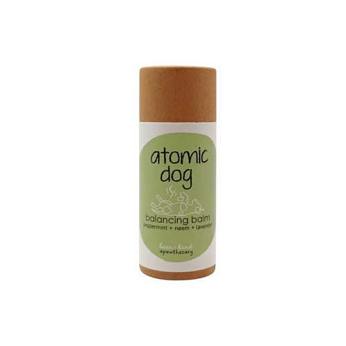 Atomic Dog balancing balm in a cylindrical container on a white background