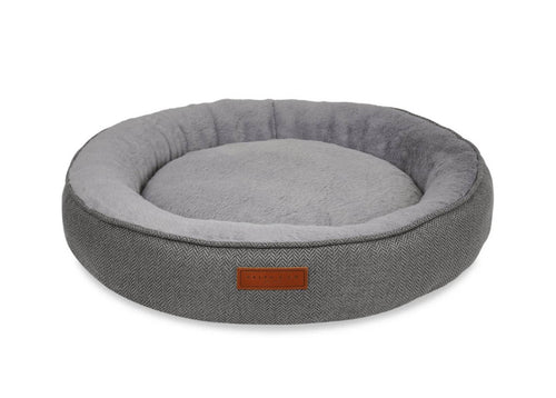 Gray pet bed with a brown label on a white background