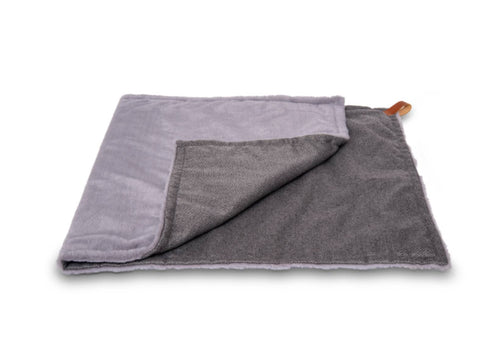 Folded gray towel with a corner tag on a white background