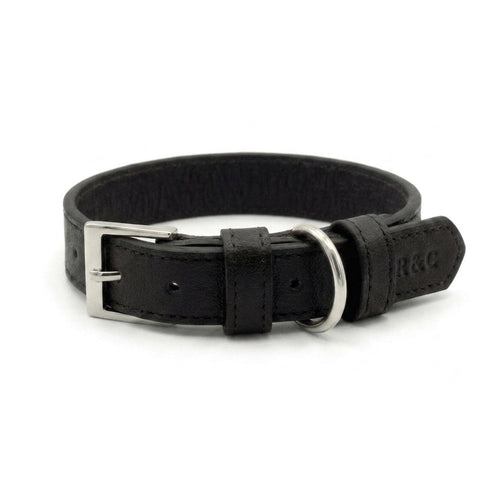 A black leather dog collar with a silver metal buckle and ring, shown on a plain white background. The brand name 'R&C' is embossed on the leather tip.