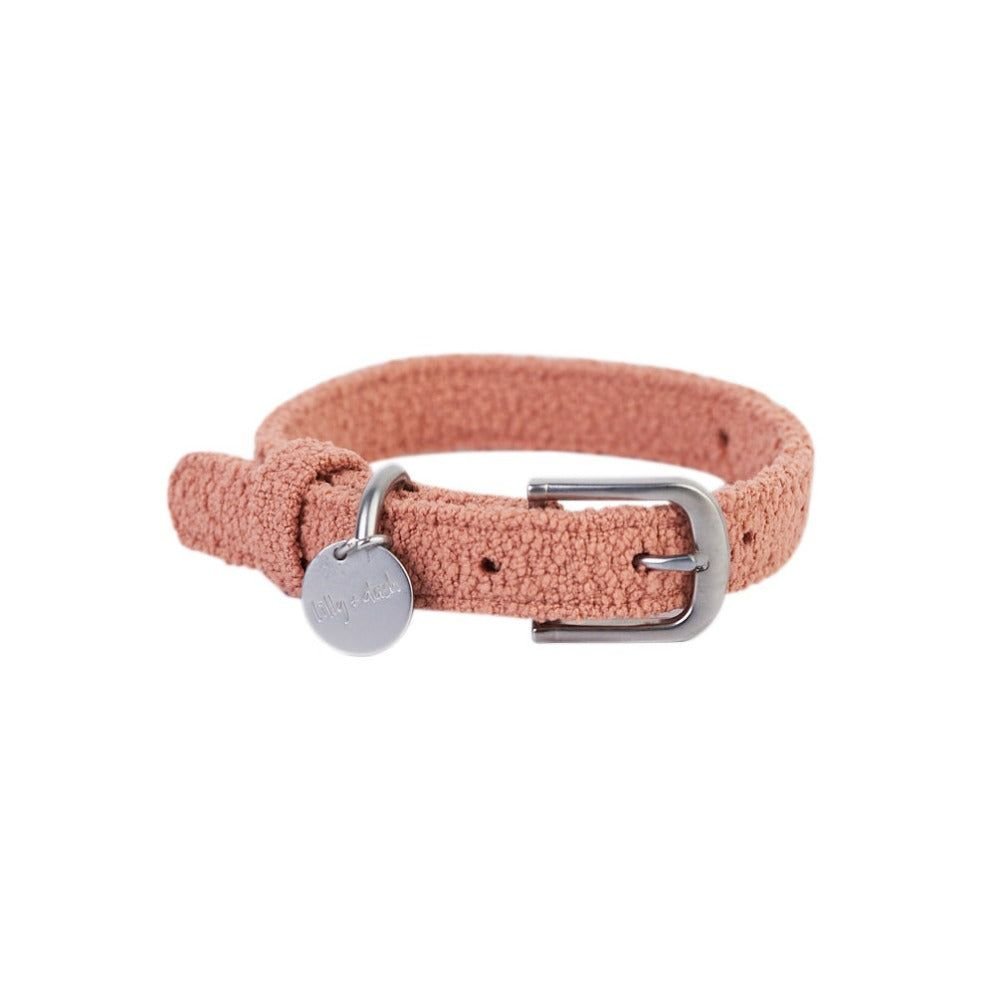 Pink woven dog collar with a silver buckle and tag on a white background