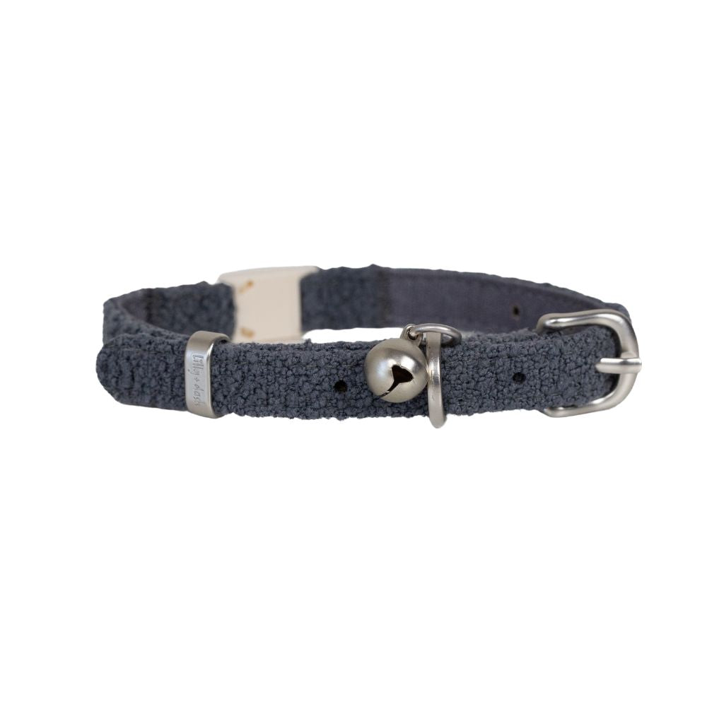 Navy blue woven cat collar with a silver bell and buckle on a white background