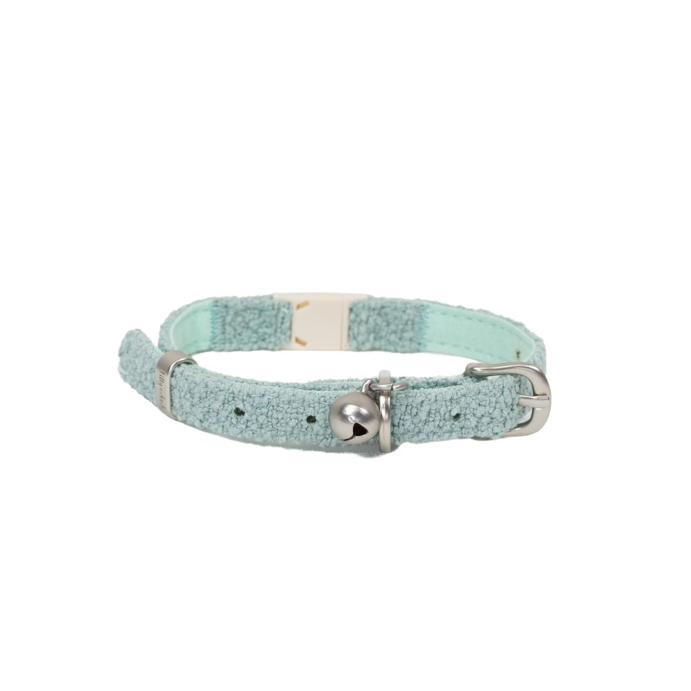 Light blue glittery cat collar with a bell on a white background