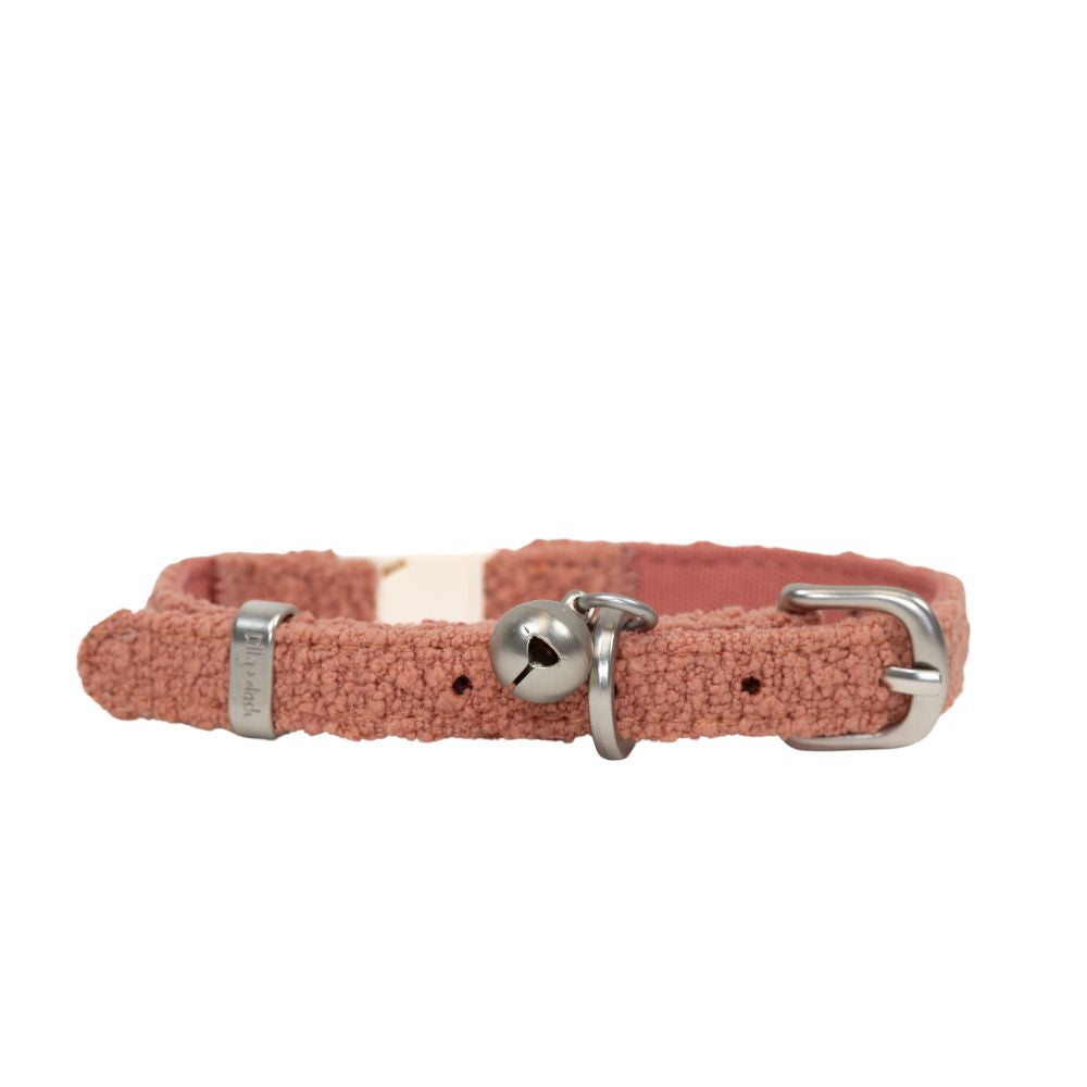 Pink cat collar with a bell on a white background