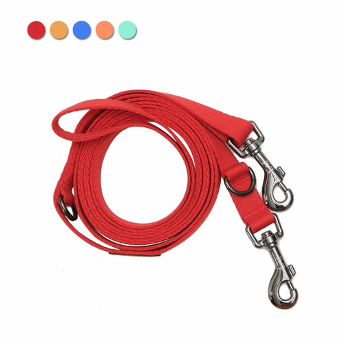 Red dog leash with metal clip on a white background