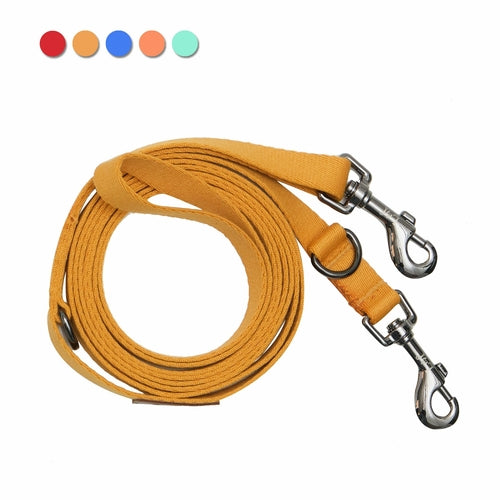 Yellow dog leash with metal clasps on a white background