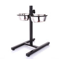 Double stainless steel dog bowl on a black stand against a white background