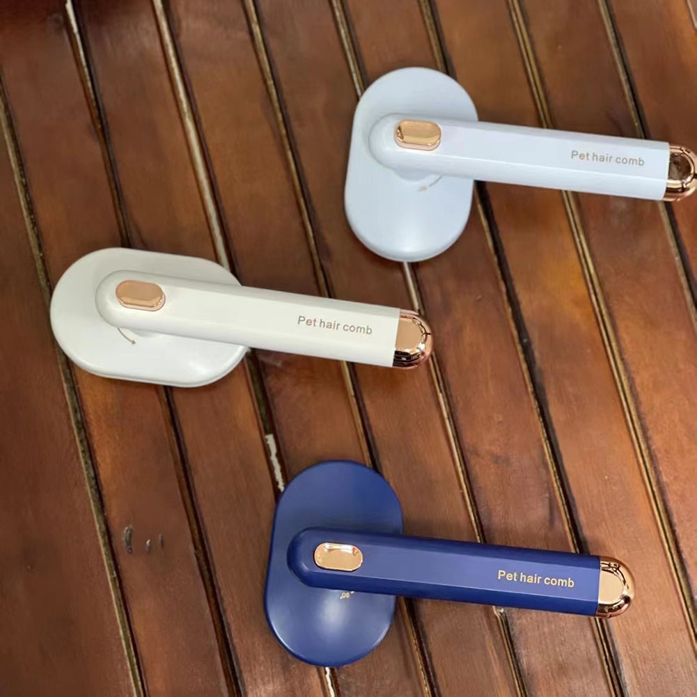 Three pet hair combs with white, gold, and blue handles on a wooden surface.