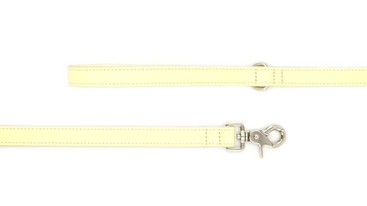 Light yellow strap with a metal clasp on a white background