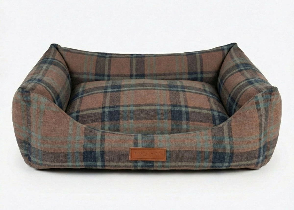 Plaid patterned pet bed on a white background