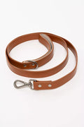 Brown leather dog leash with metal clip on a white background
