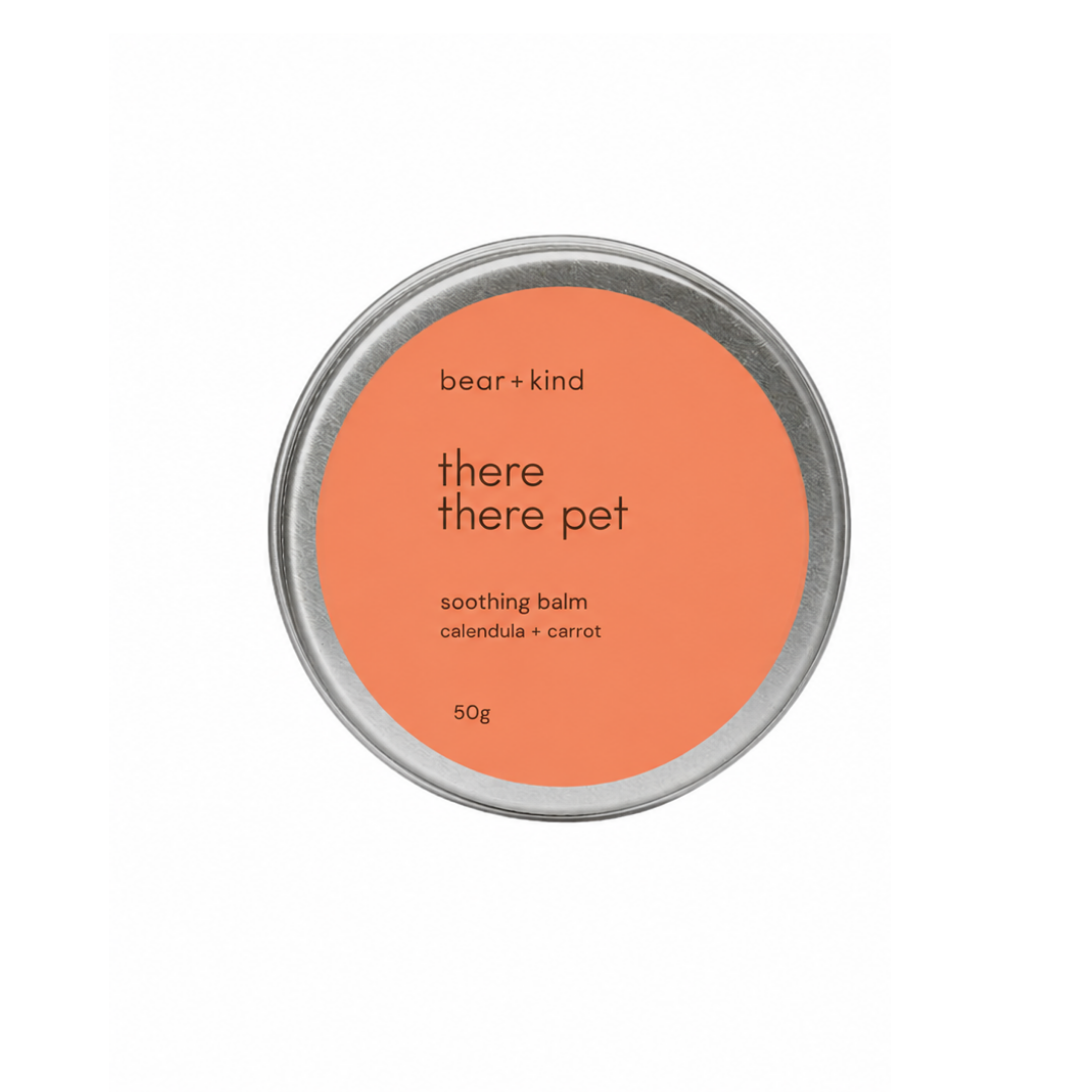 A round silver tin of bear + kind 'there there pet' soothing balm, featuring a bright orange label on a clean white background.