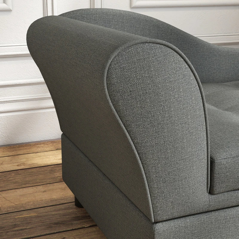 Gray upholstered chair with wooden floor and white wall background