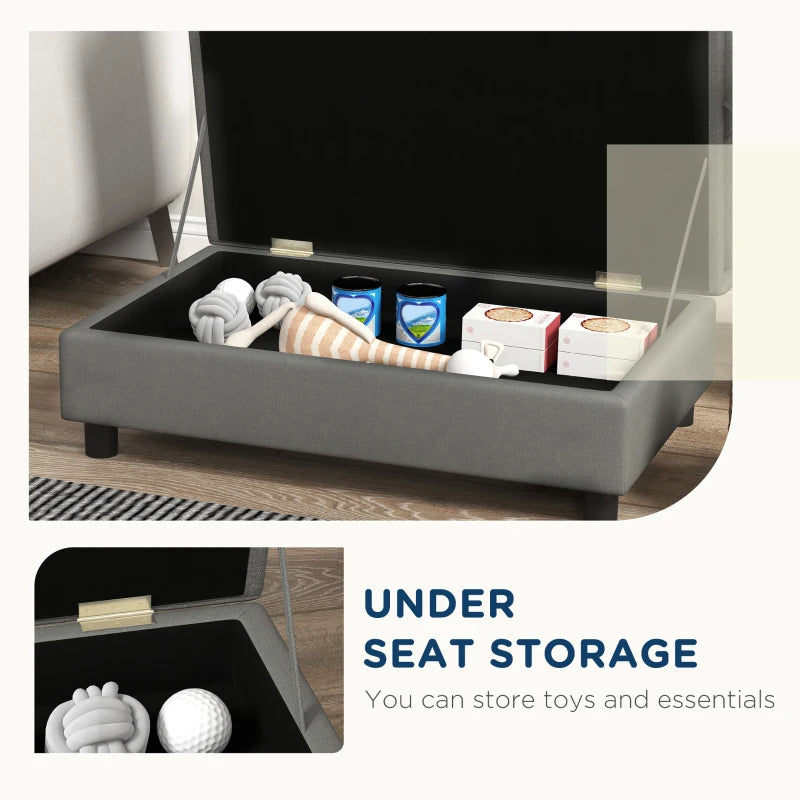 Gray ottoman with open lid showing storage space, including toys and essentials.
