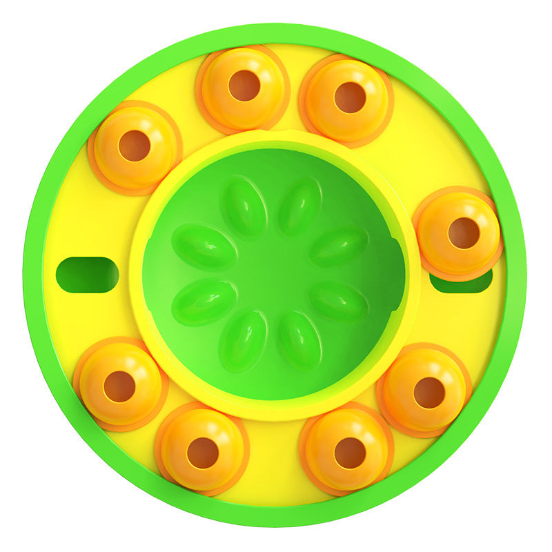 A circular plastic toy wheel or spinner with a bright yellow outer ring, green inner ring, and multiple orange wheel segments around the perimeter, shown on a plain white background.