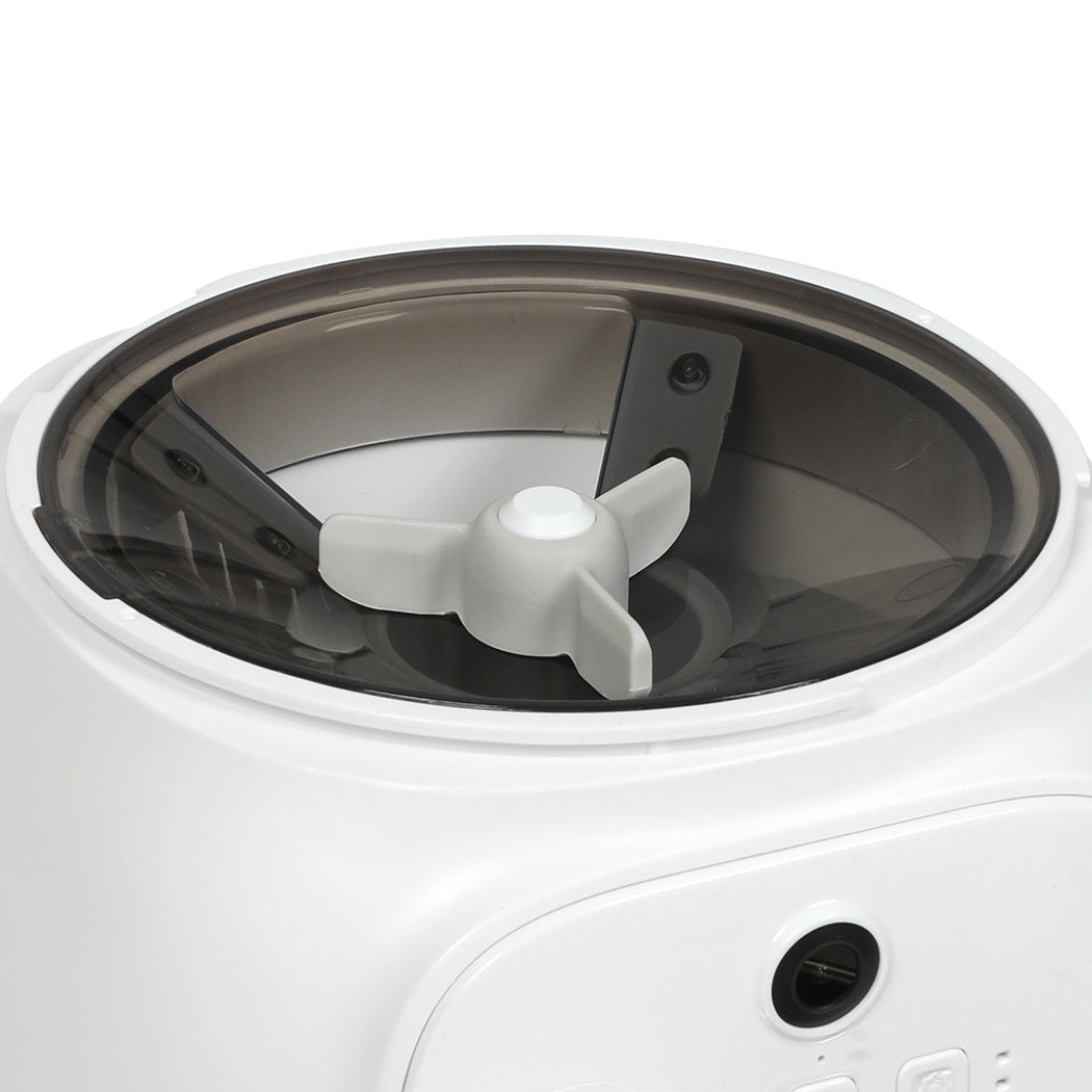 Close-up of a kitchen appliance with a clear container and white base.